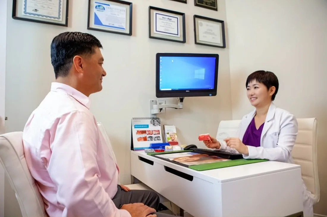 Dr. Park explaining findings to a patient at Green Dentistry